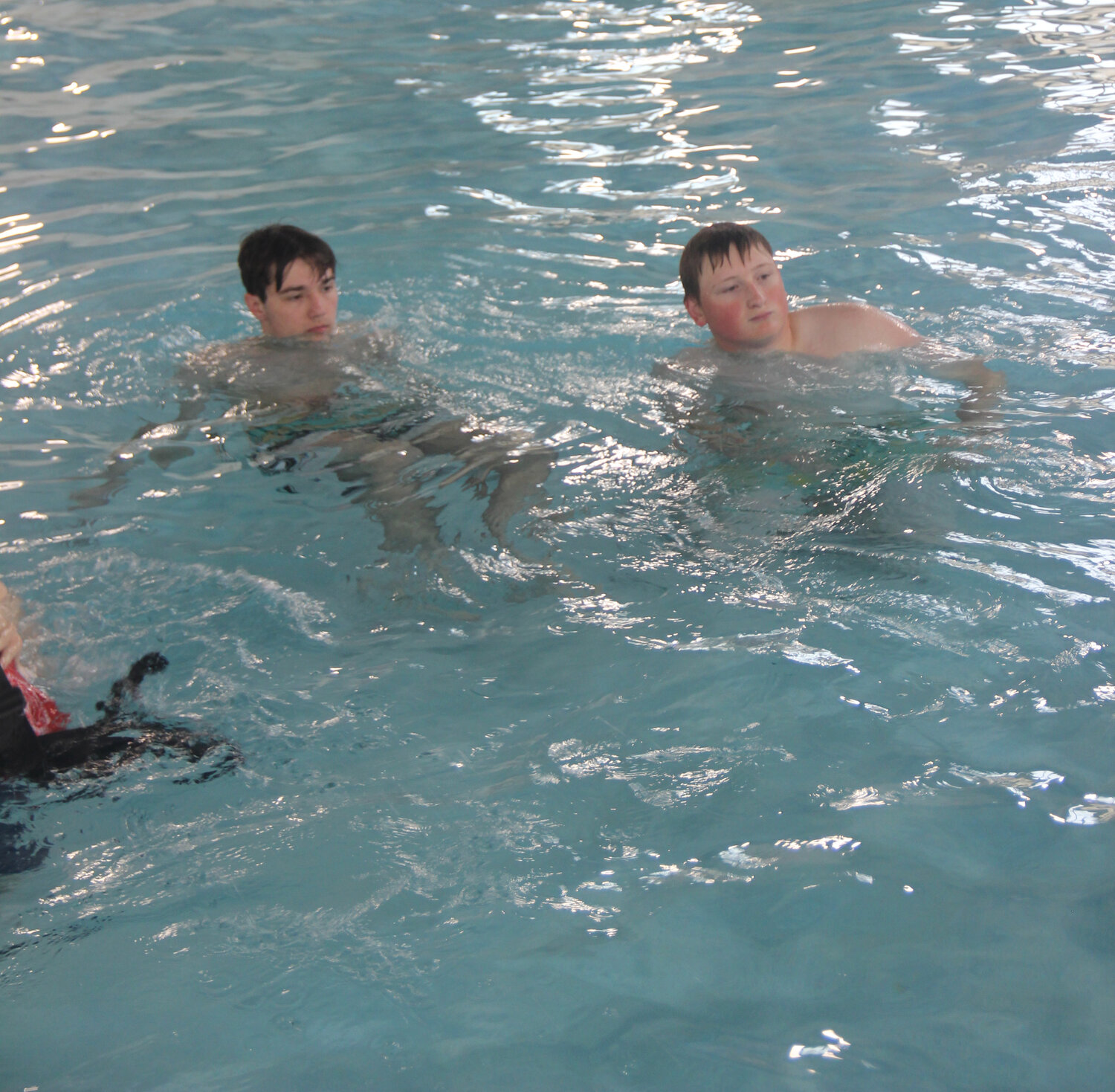 Jacob Nagle and Cooper Stone listen to instruction during lifeguard training class.