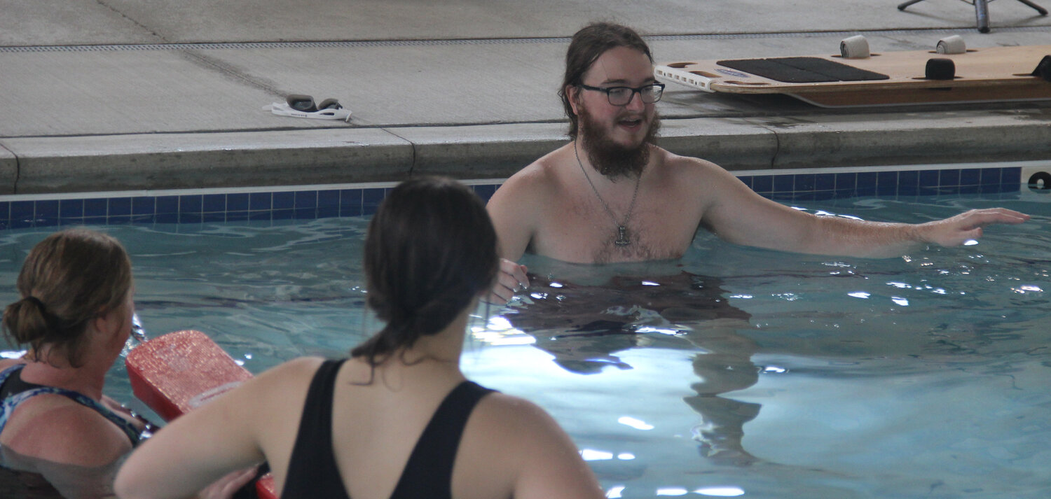 Cole McBride offers instruction to the lifeguard candidates while Tamara Wurth and Miakoda Rhodes look on.