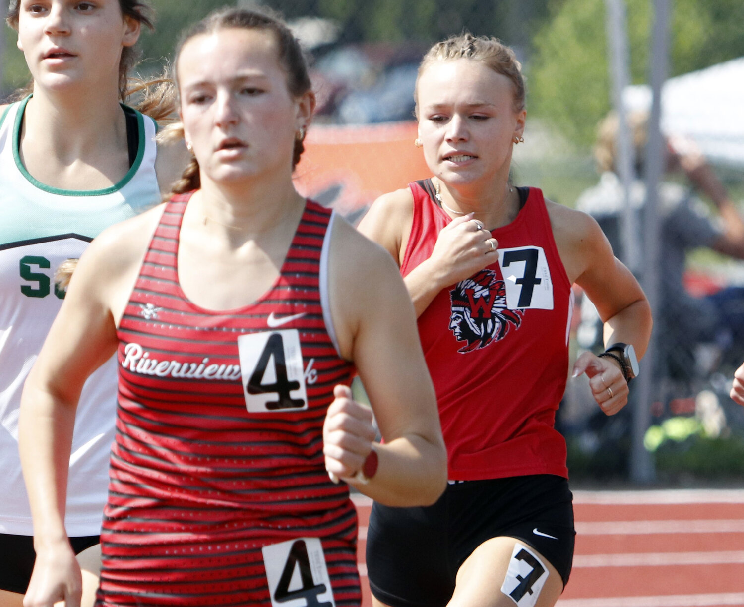 Madelyn Marschhel (right) looks to catch the leader of the pack during the 800-meter run.