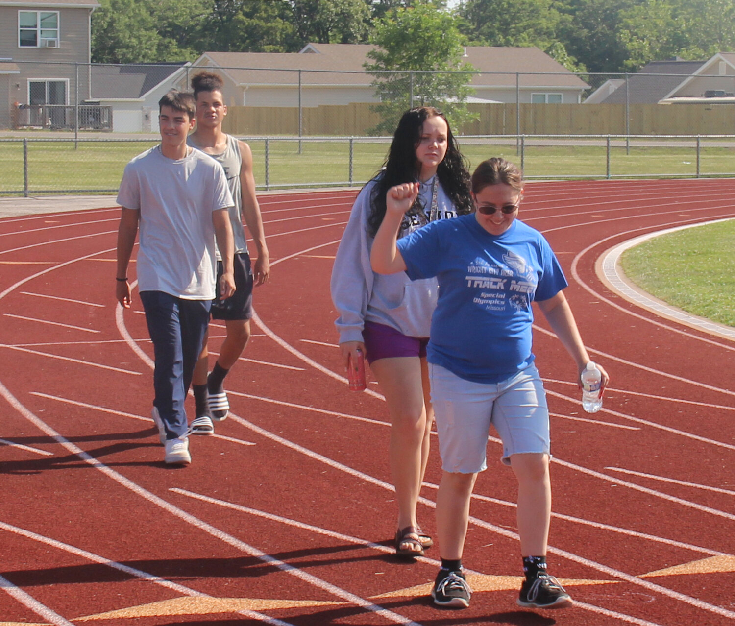 A student pumps her first as the last few students complete the practice processional during Wright City High School graduation rehearsal.
