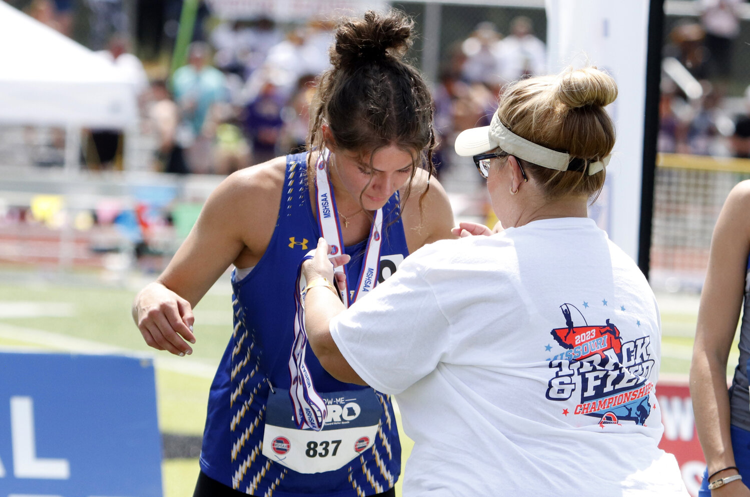 Elizabeth Riggs receives her state medal after placing sixth in the 300-meter hurdles at the state track and field meet.
