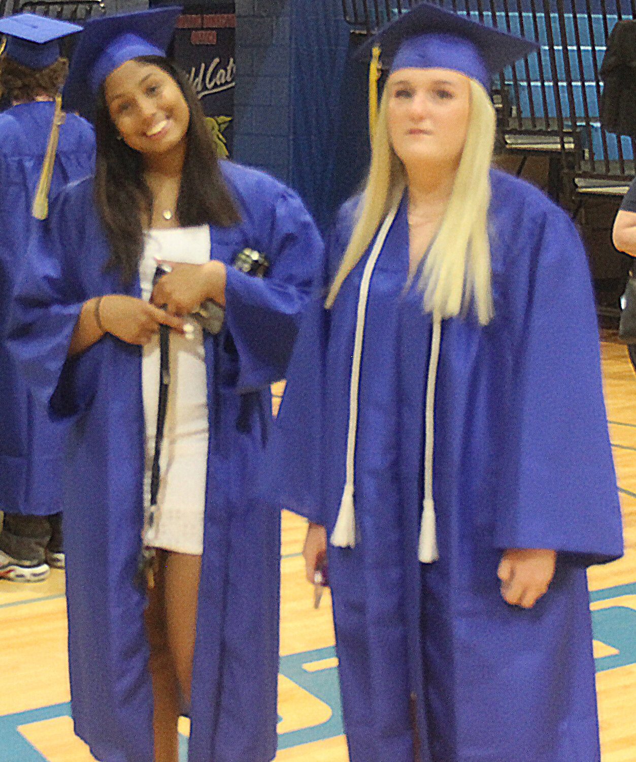Two Wright City High School seniors enjoy a moment in the gym before the class picture was taken.