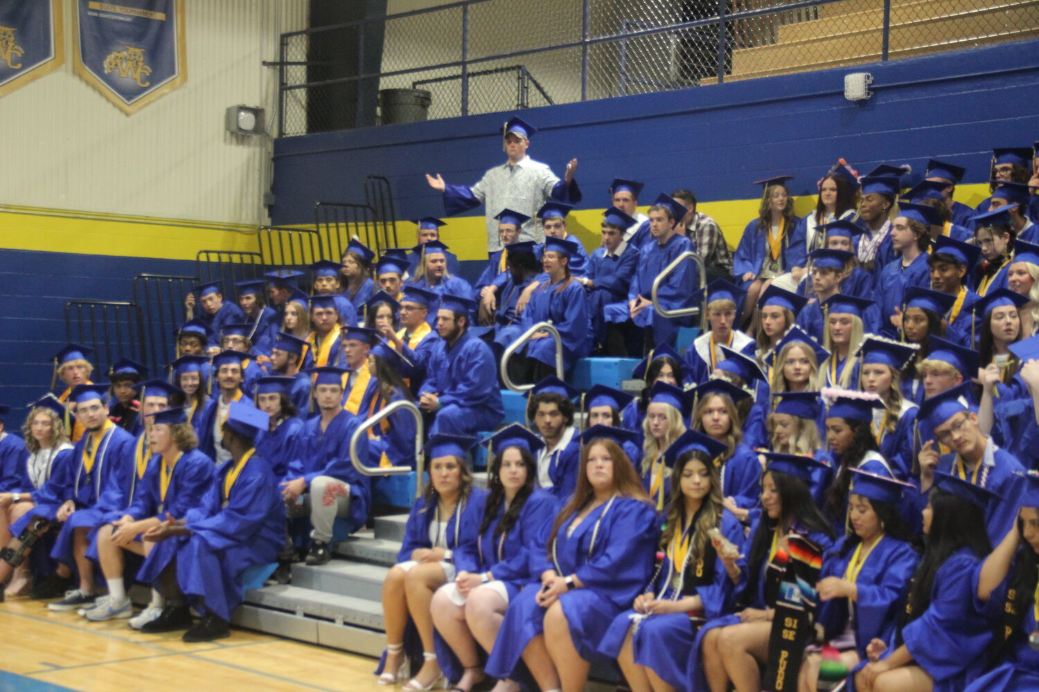 One Wright City High School senior provides some humor as students prepare for the class picture.
