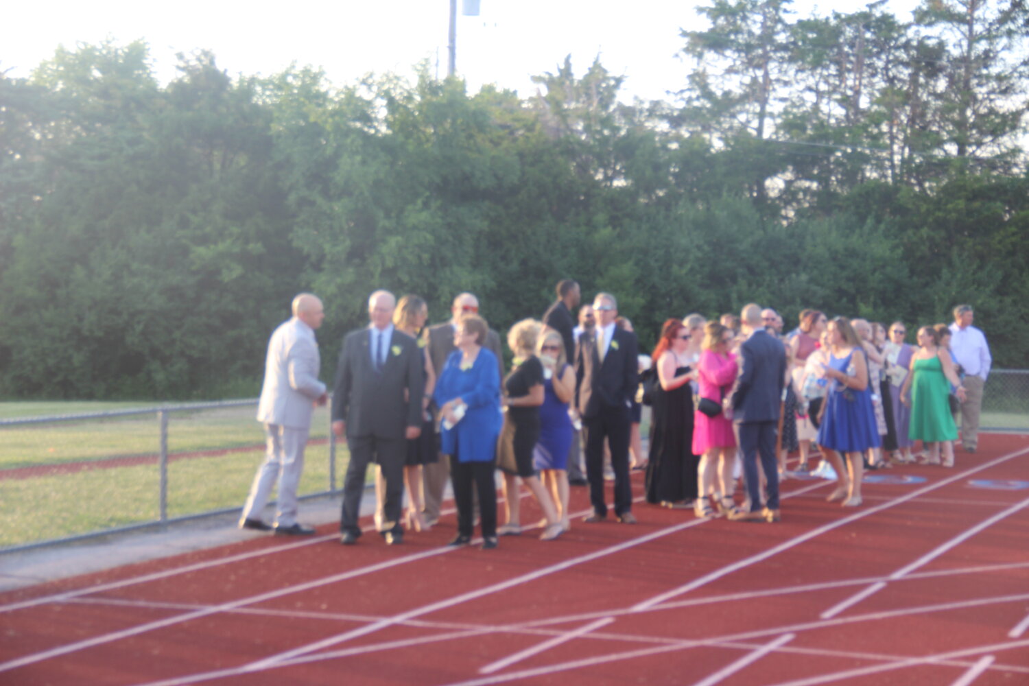 School district officials and teachers line up on the track prior to the start of the Wright City High School graduation ceremony on June 2.