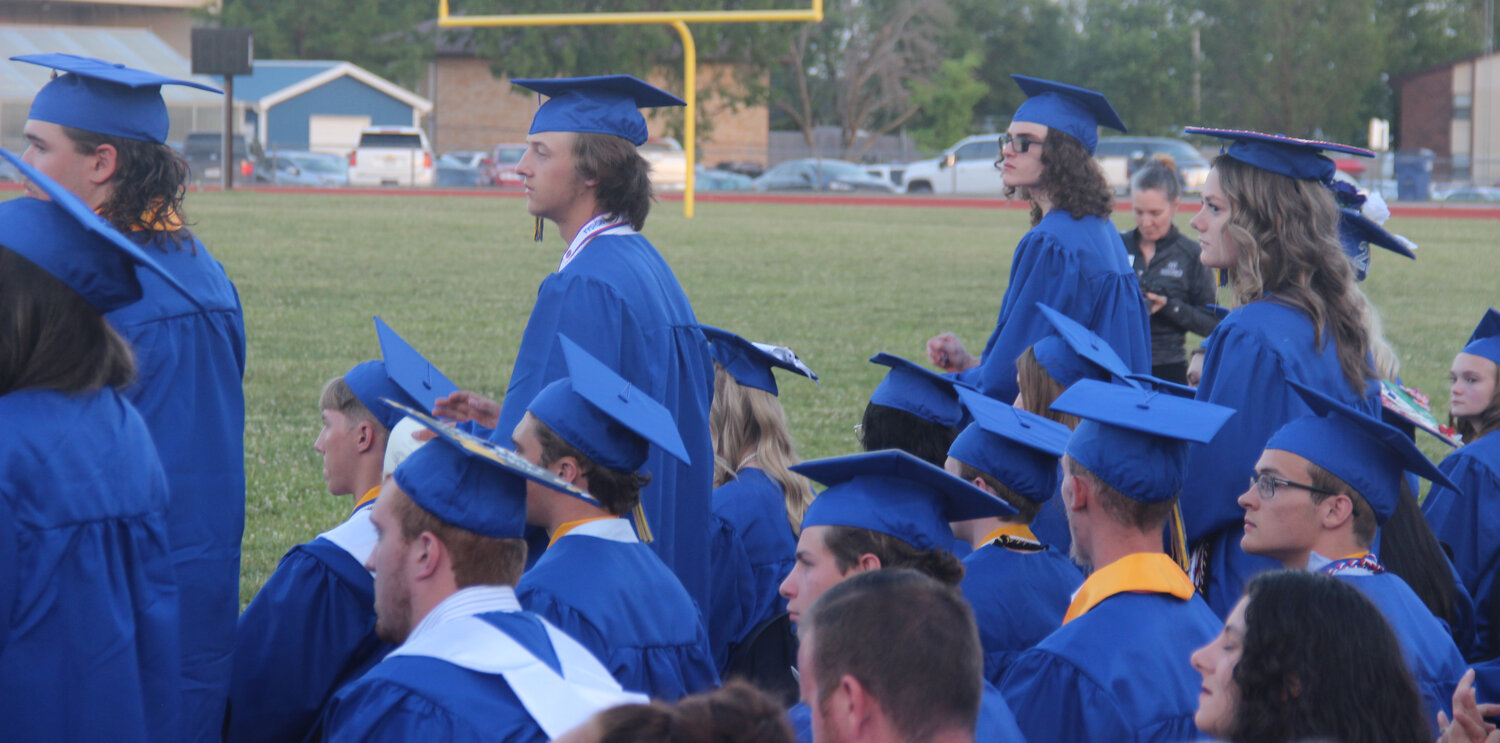 Students of the year stand as their names are announced during the Wright City High School graduation ceremony.