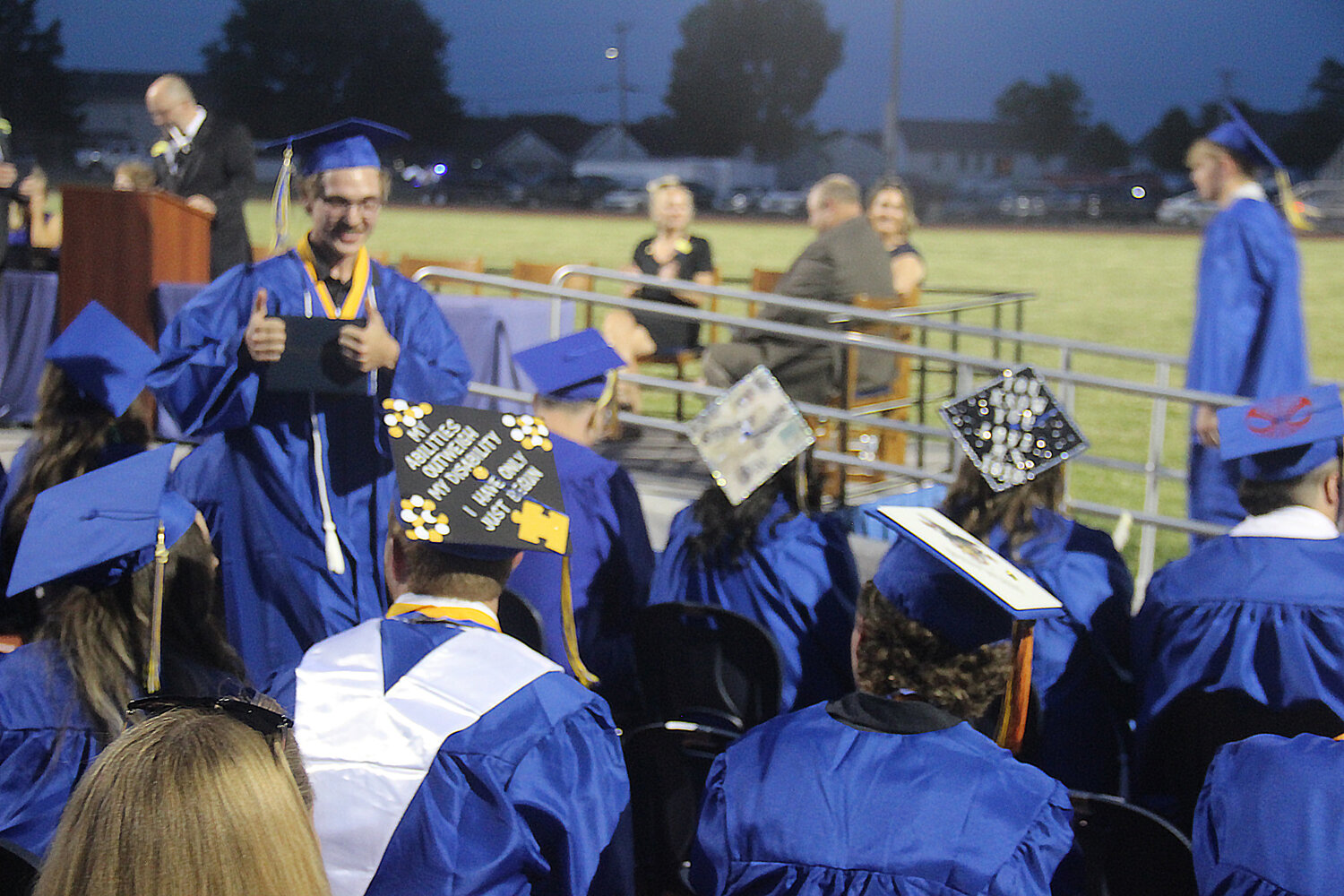 A senior gives a thumbs up as he returns to his seat after receiving his diploma cover during the Wright City High School graduation ceremony on June 2.