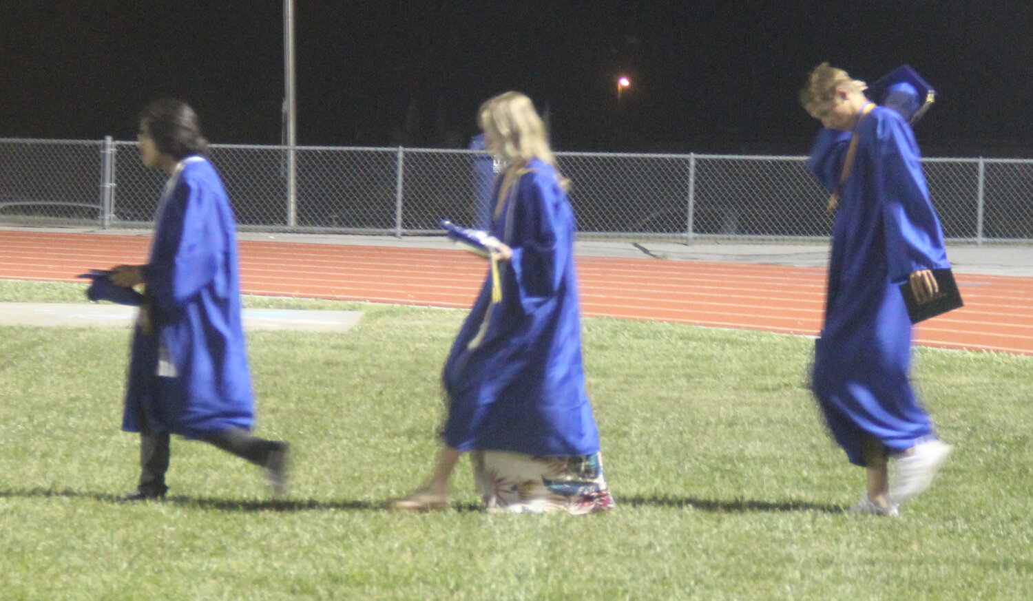 The Class of 2023 walks out to the football field to await their family and friends at the conclusion of the Wright City High School graduation ceremony.