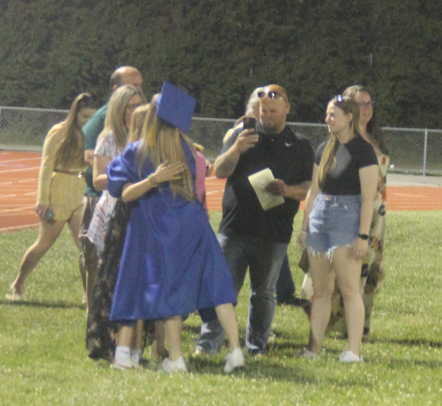 A Wright City High School graduate is embraced by her family following the ceremony.