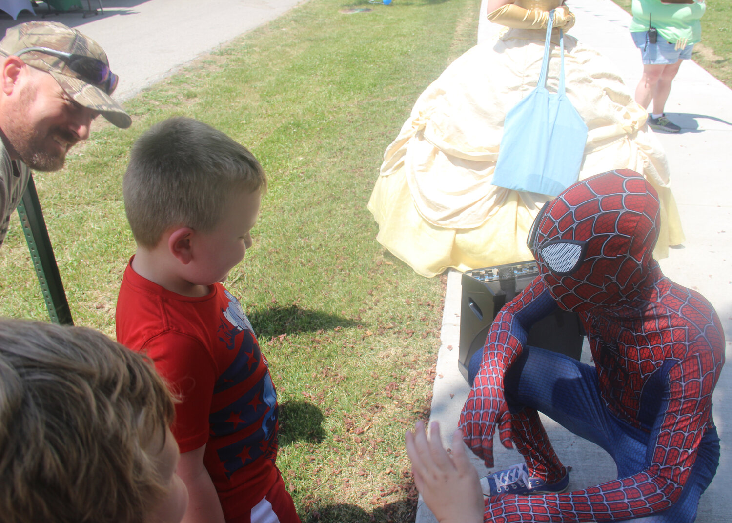 Spiderman greets a young boy during Summerfest.