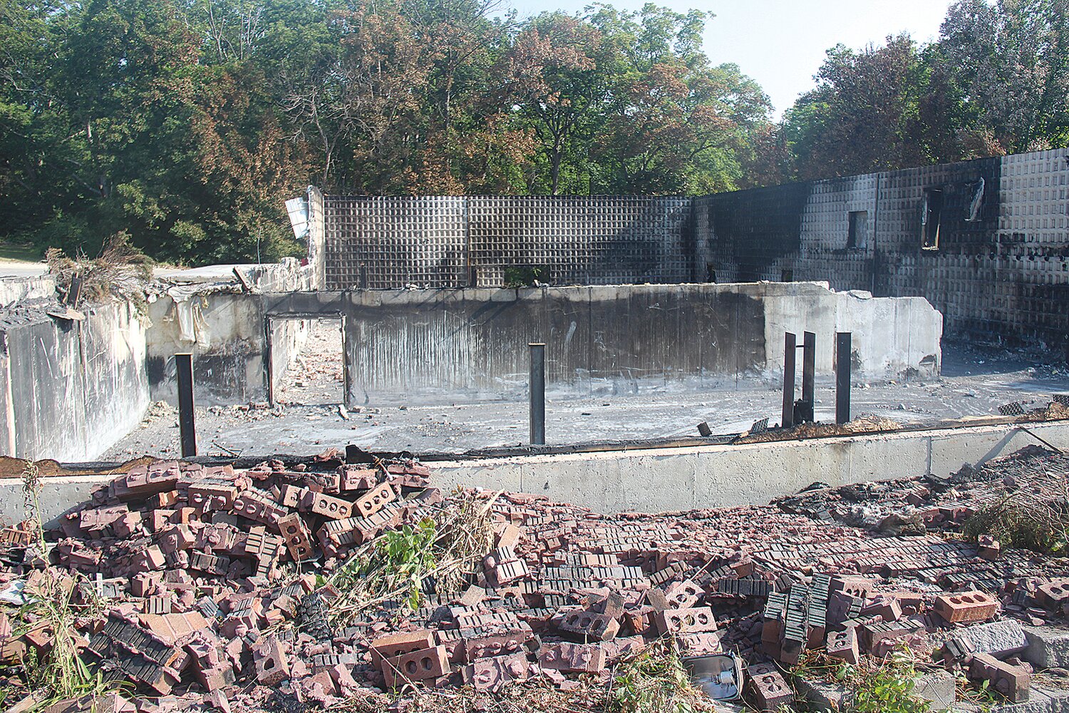 The back wall and the foundation of Abundant Life Church in Warrenton is all that remains following the June 12 fire.