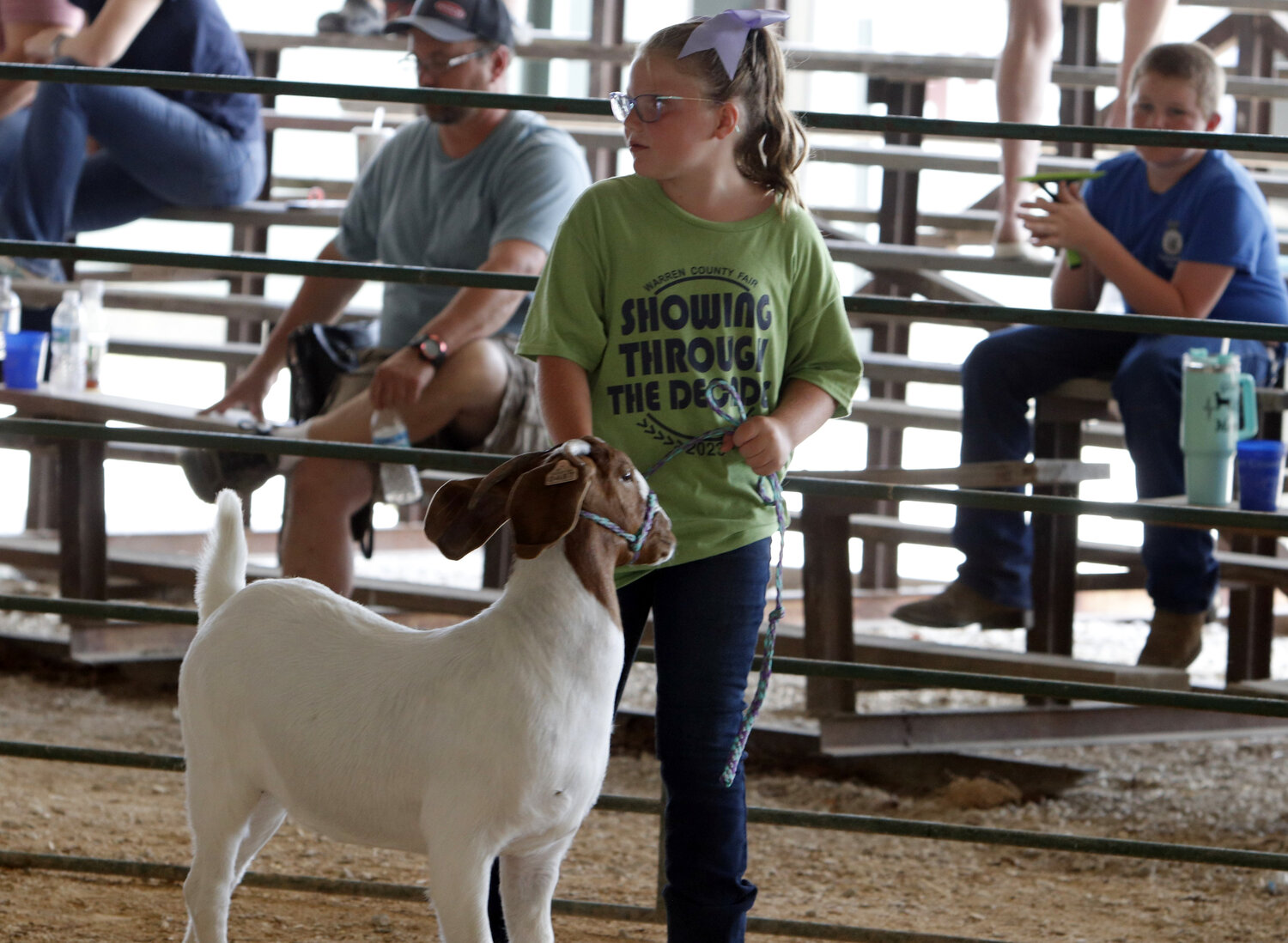 Morgan Daehnke looks toward the judge during the goat show at the Warren County Fair.