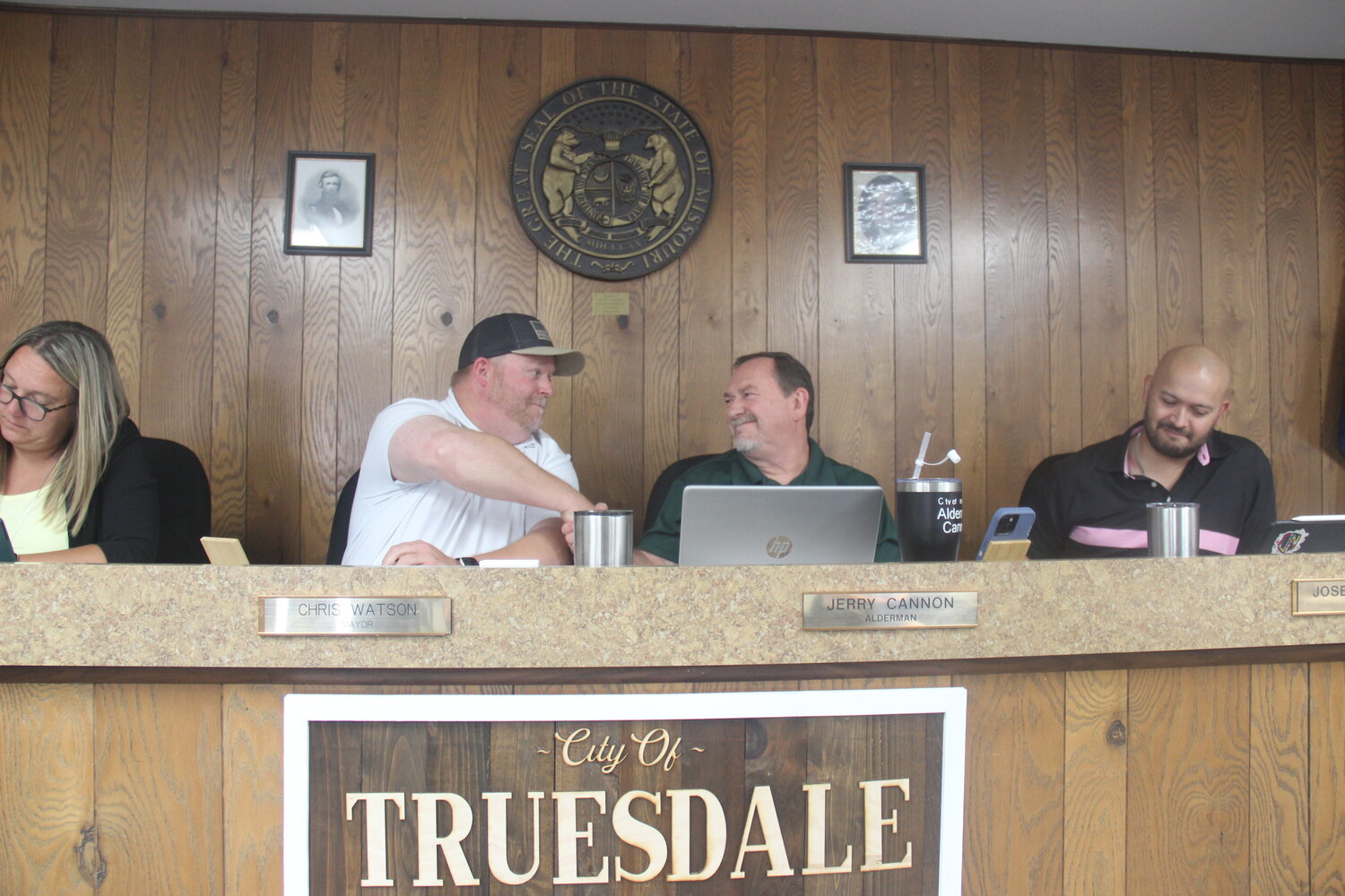 Outgoing Truesdale Mayor Chris Watson shakes hands with newly-appointed Mayor Jerry Cannon at the end of the June 28 board of aldermen meeting.