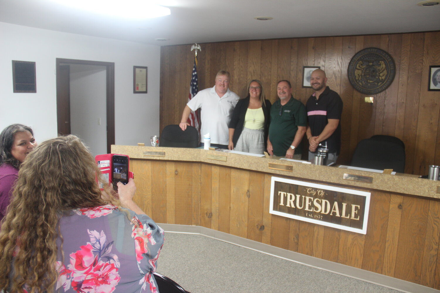 Truesdale City Treasurer Missy Bachamp takes a photo of new Mayor Jerry Cannon and the current board of alderman, from right, Mike Thomas, Keri Hartley, and Joe Brooks.