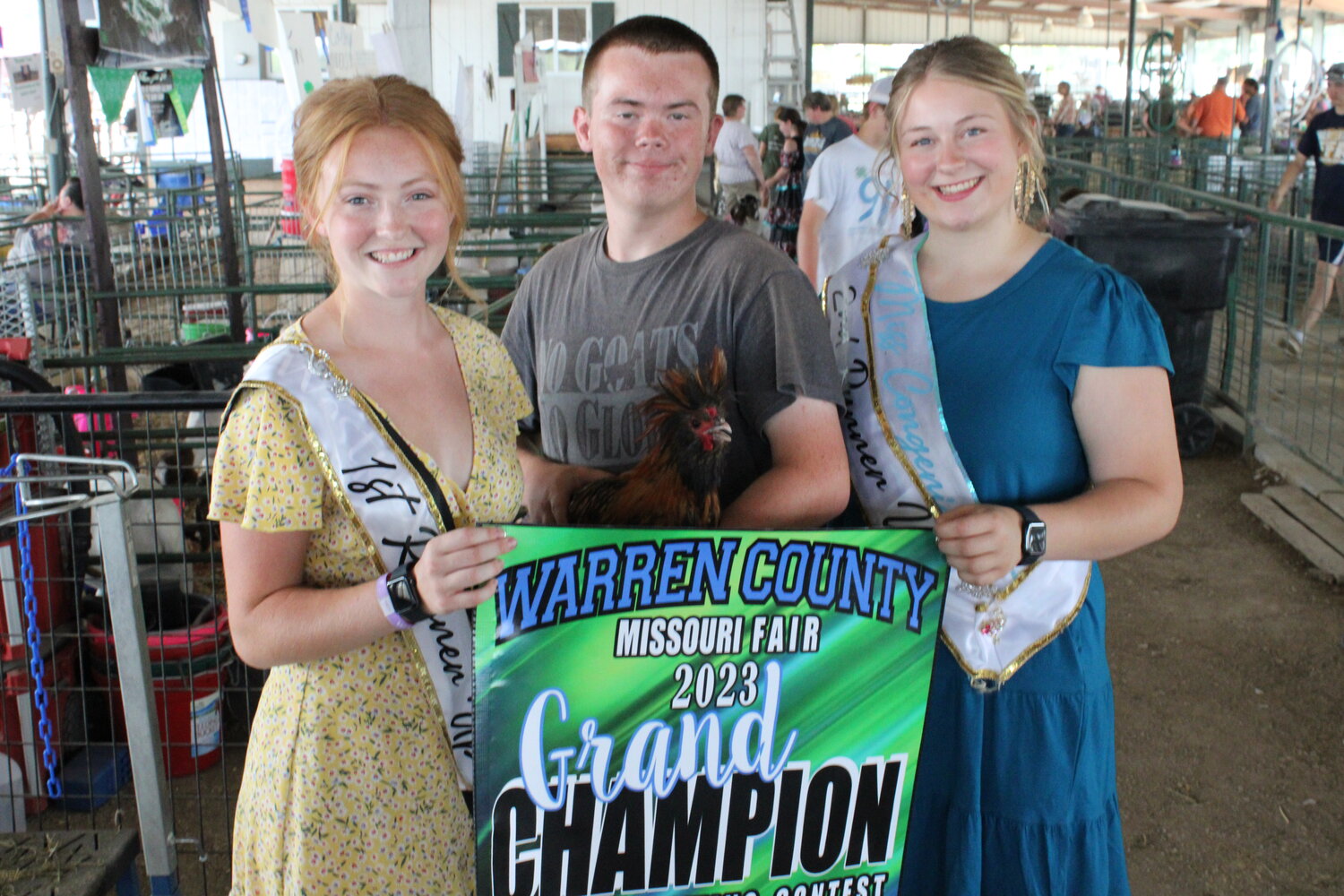 Rhett Karrenbrock, center, poses with Allison Duncan and Grace Schlansker after winning the rooster crowing competition on July 7 at the Warren County Fair.