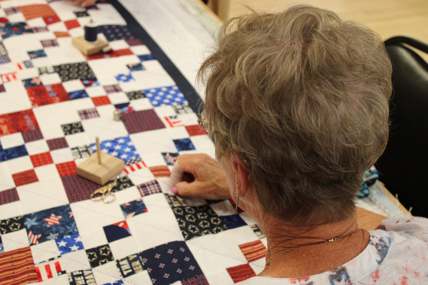 A quilter makes a stitch on one of the quilts that will eventually be donated to a veteran in Eastern Missouri.