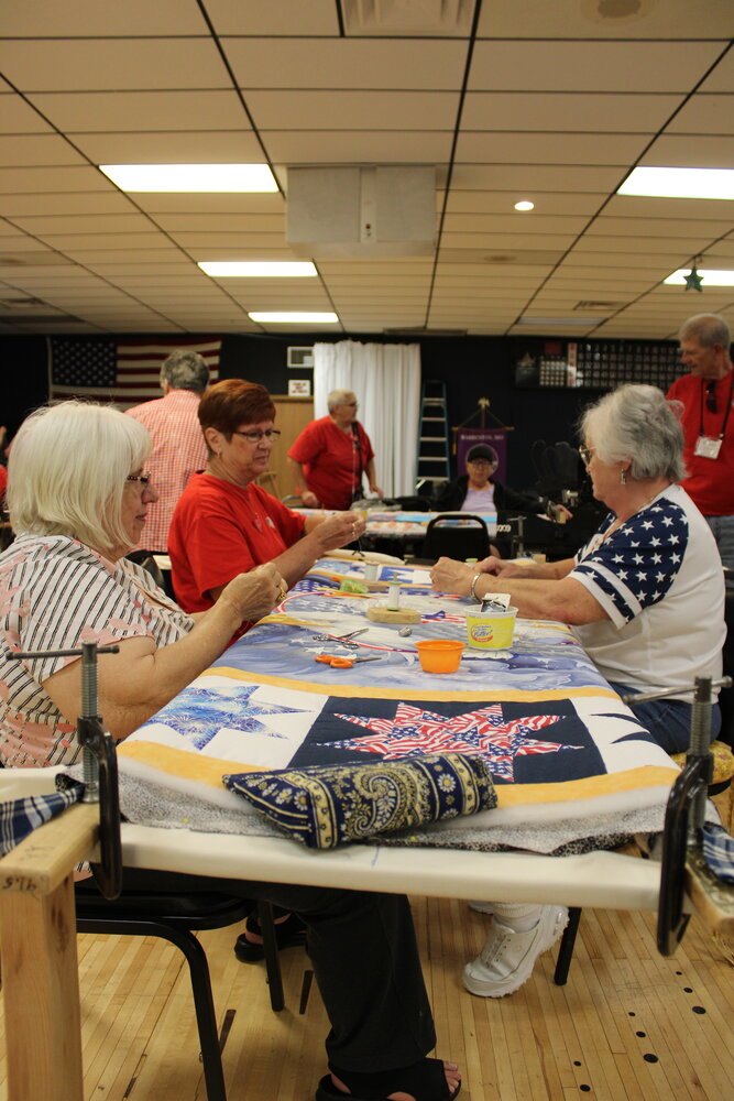 Brenda Kenney, right, and other members of Quilts of Valor Eastern Missouri work on a quilt at the Elks Lodge in Warrenton.