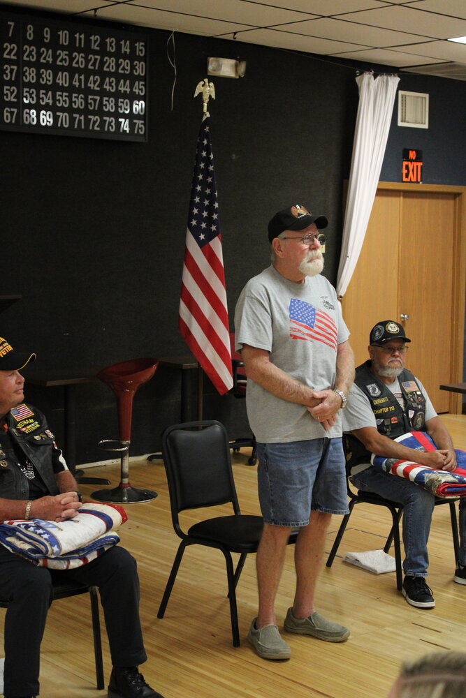Rob Miller stands as he is honored by Quilts of Valor Eastern Missouri quilters on July 12 in Warrenton.