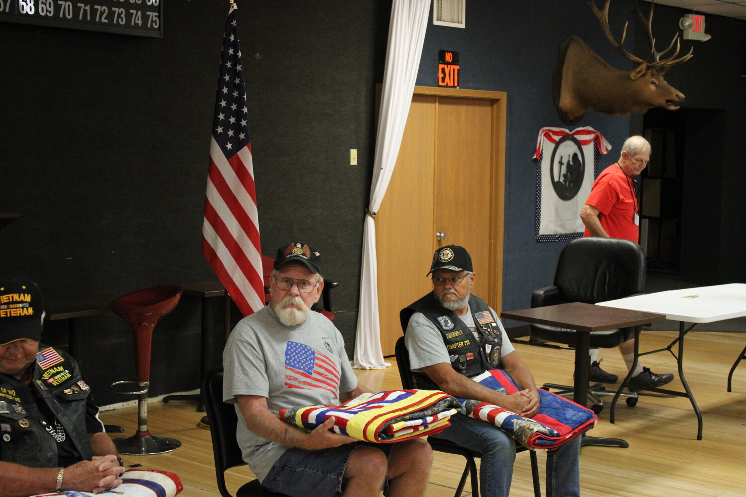 Rob Miller, of Warrenton, holds his quilt as he listens to the end of the presentation July 12 at the Elks Lodge.