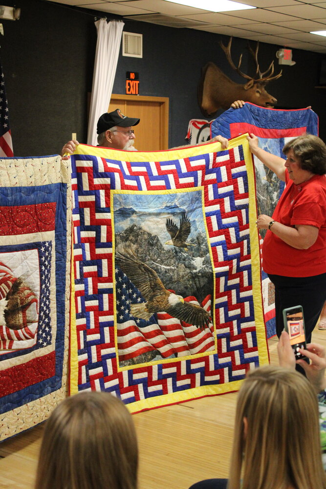 Rob Miller, of Warrenton, displays the quilt given to him by the group Quilts of Valor - Eastern Missouri during a ceremony on July 12. He is assisted by Marlene Walton, who also nominated him for the honor.