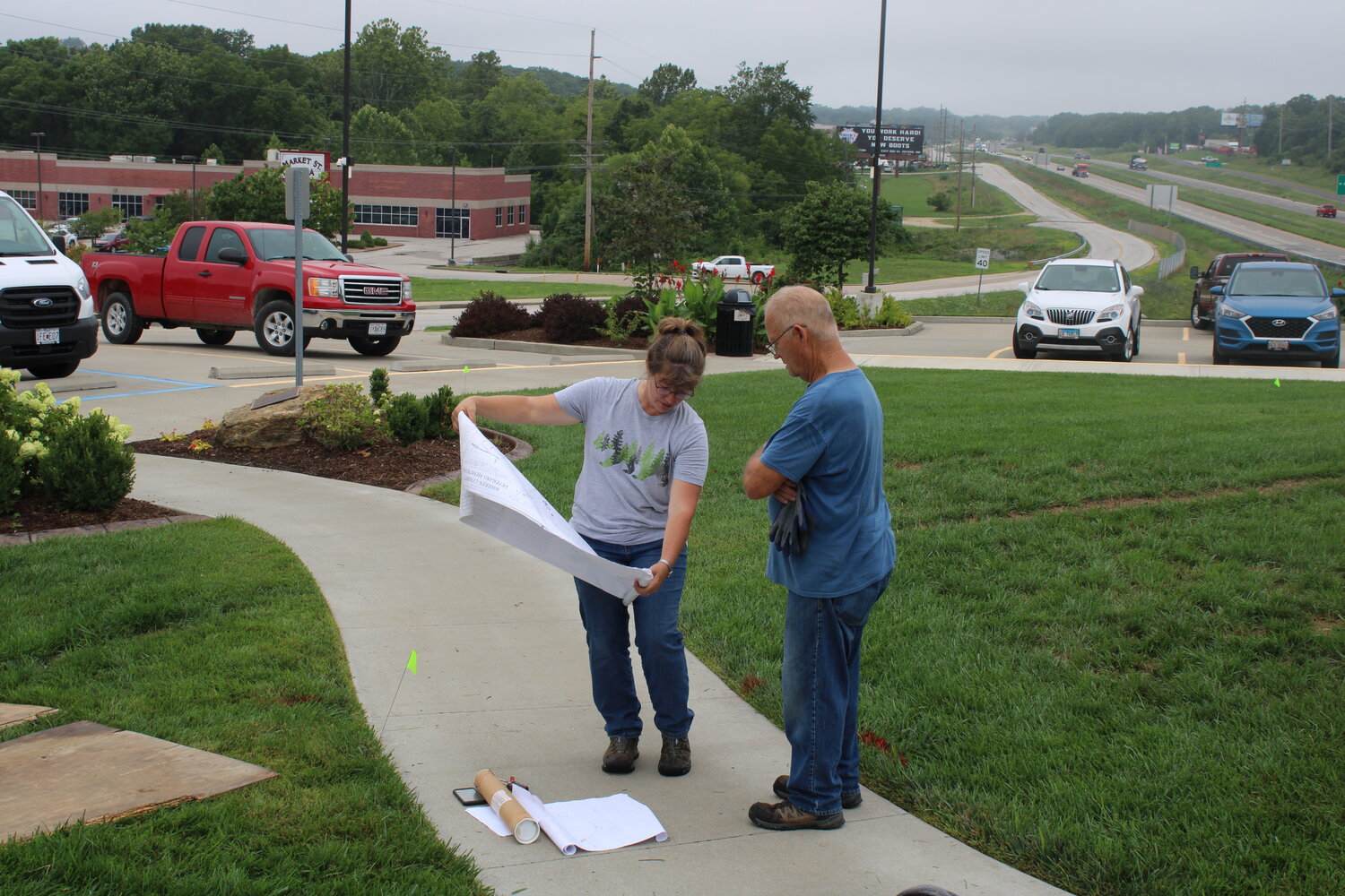 Susan Ehlenbeck and Tom Carter look over the plans for the site of the Charters of Freedom before breaking ground.