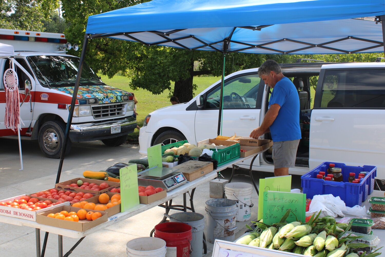 John Kopmann, a vendor at the Warren County Farmers and Artisans Market in both Warrenton and Wright City, sets up his fresh produce for sale on Aug. 1.