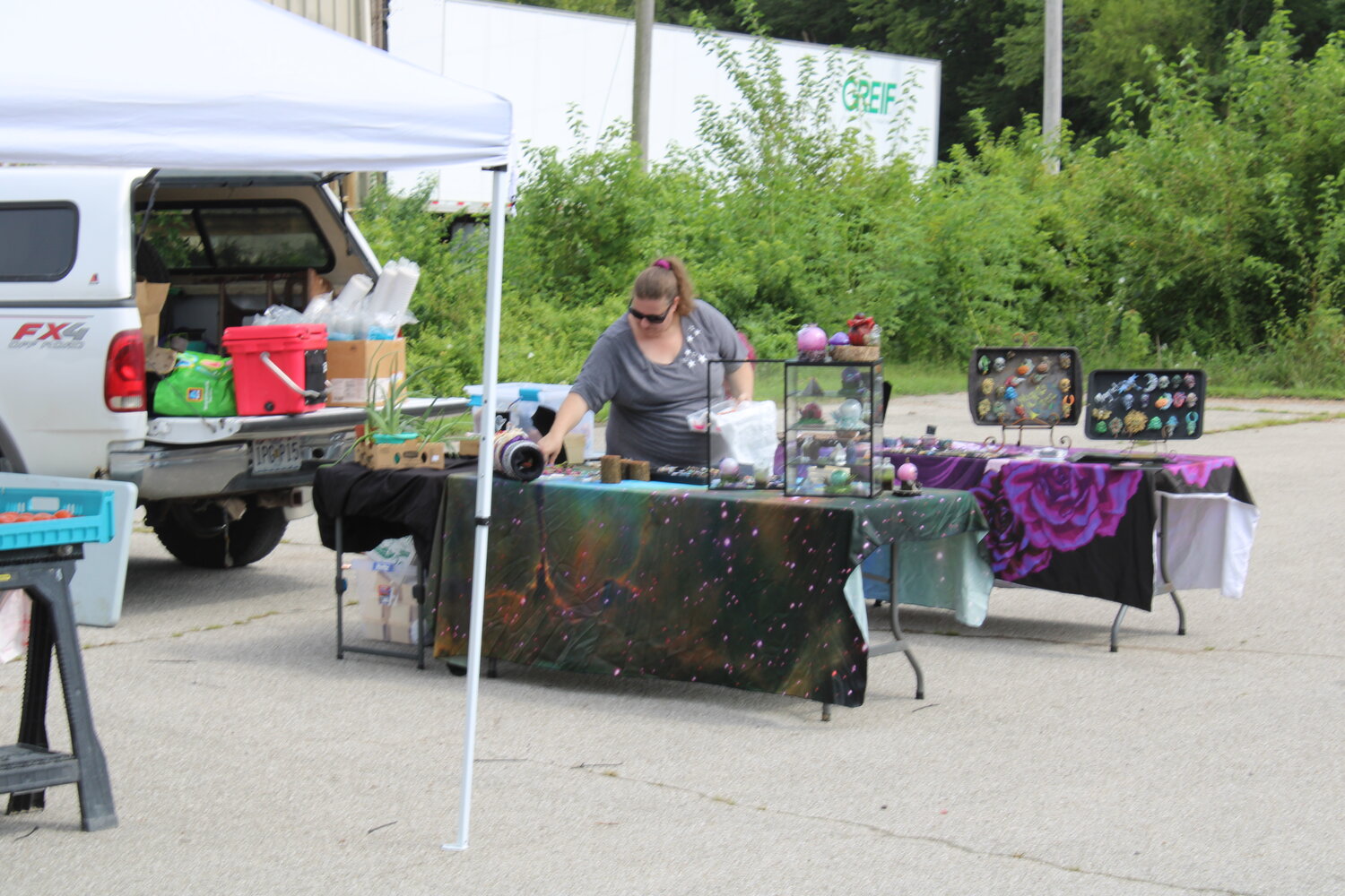 A vendor sets up her booth at the Wright City market on Aug. 3.