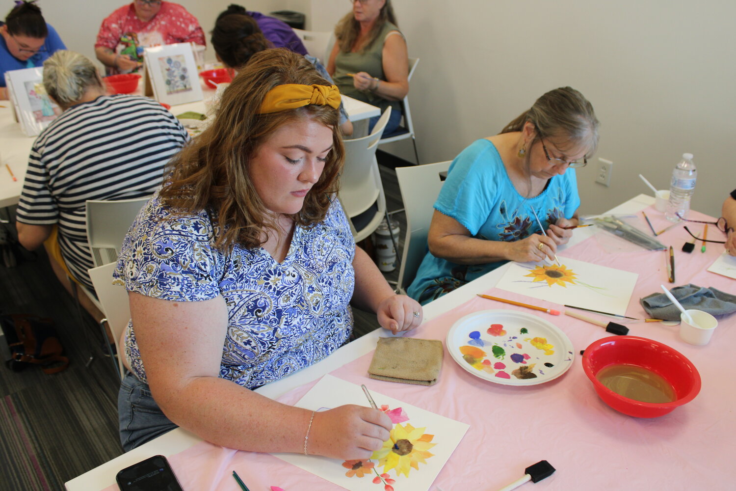 Abigail Schaefferkoetter and Cindy Trotter work on their watercolor paintings.