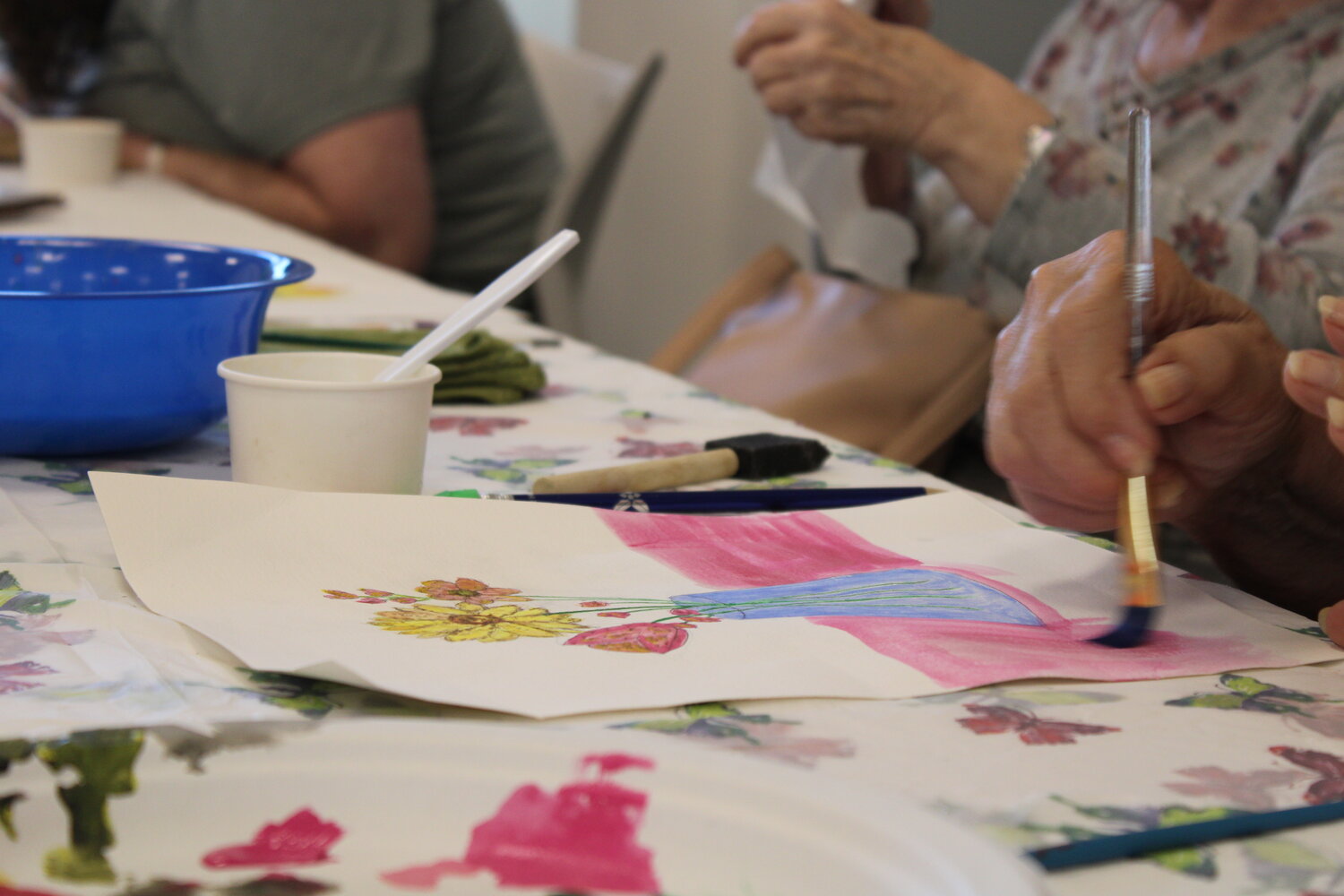 A watercolor painting is shown in progress during the event at the library.