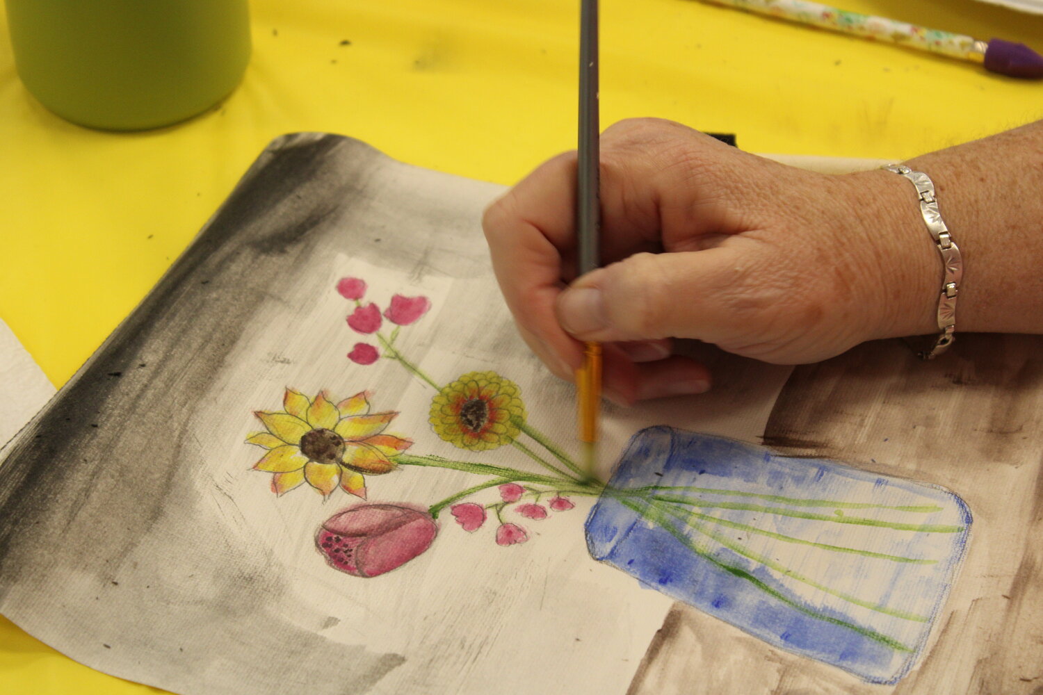 Linda Douglas works on her watercolor painting during the event at the Warrenton Scenic Regional Library.