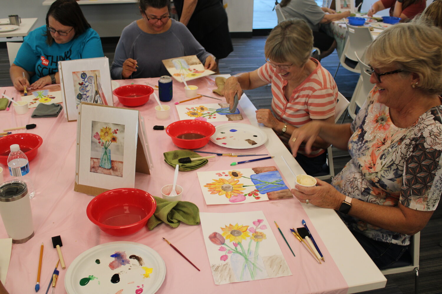 Hillary Edwards, Jaime Strauss, Terri Lenzenhuber, and Lisa Owenby work on their designs while also enjoying each other's company during the watercolor event at the library.