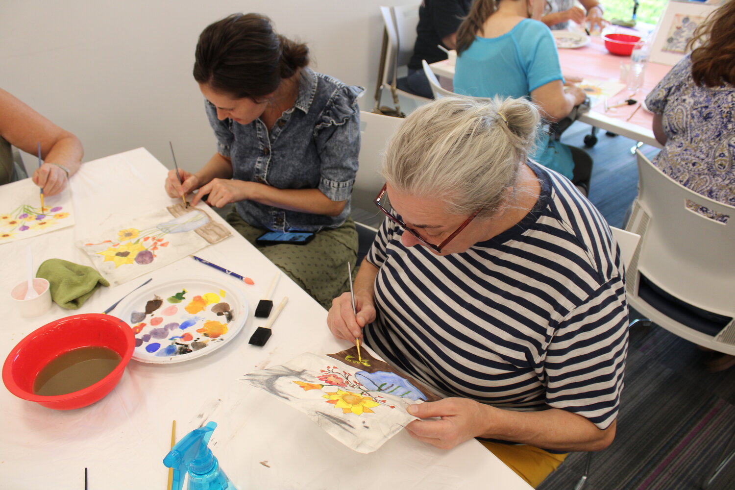 Shannon and Brigitte Gardner work on their watercolor paintings.