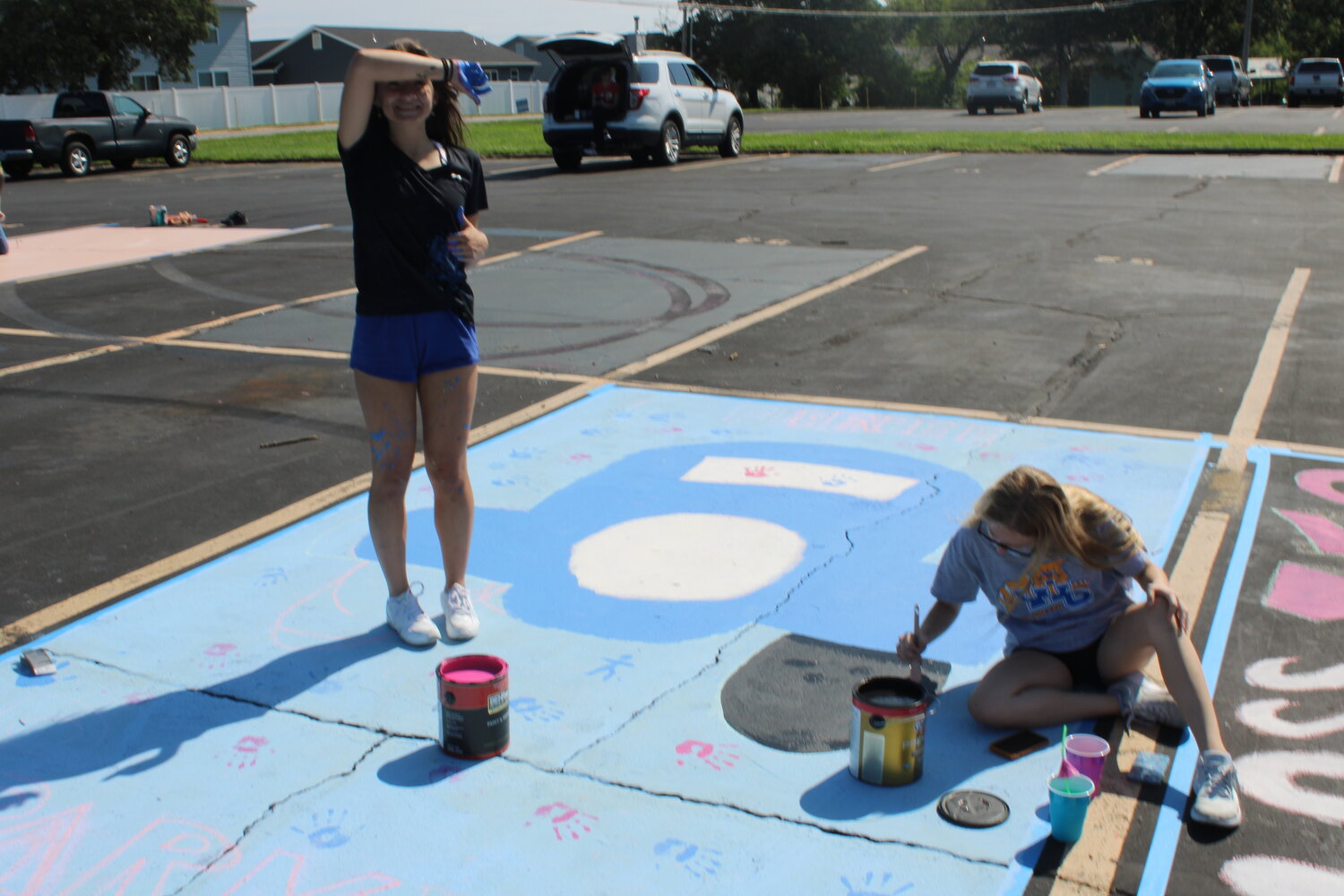 Incoming Wright City seniors Cloe Stuart and Mackenzie Reynolds work on painting a parking spot.