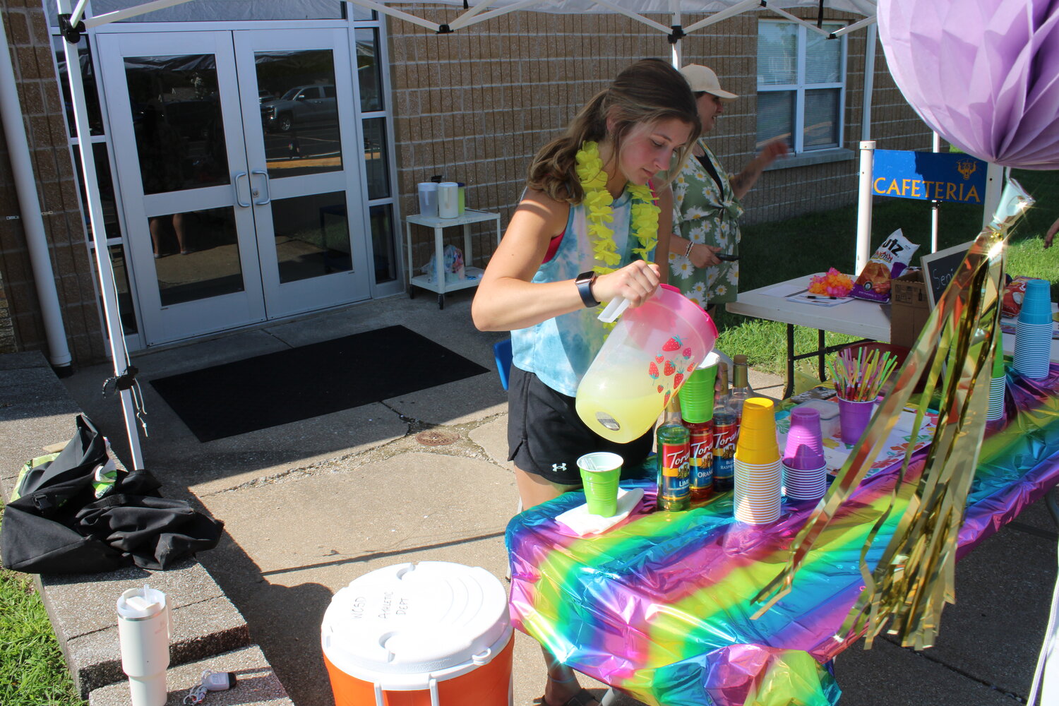 Sam Finch was helping run the lemonade stand that provided free drinks for the students who were out with their designs. The lemonade was provided by the class as a whole so no one had to pay for it.