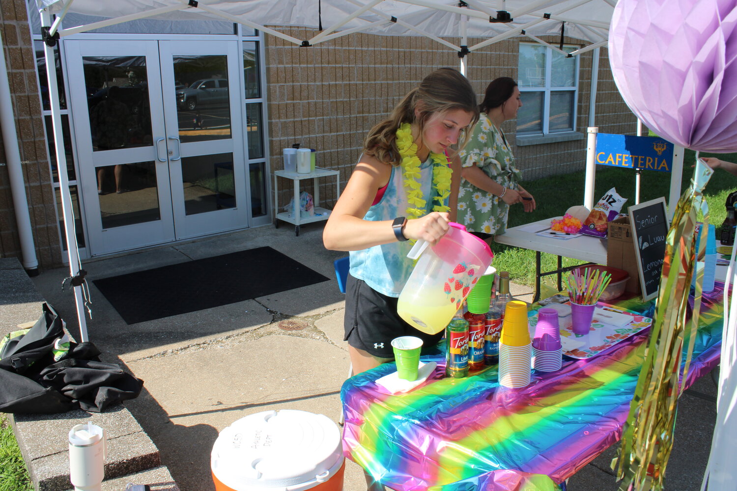 Sam Finch was helping run the lemonade stand that provided free drinks for the students who were out with their designs. The lemonade was provided by the class as a whole so no one had to pay for it.