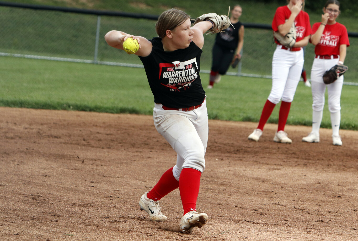 Audrey Lanzone prepares to throw the ball to first base during an August practice