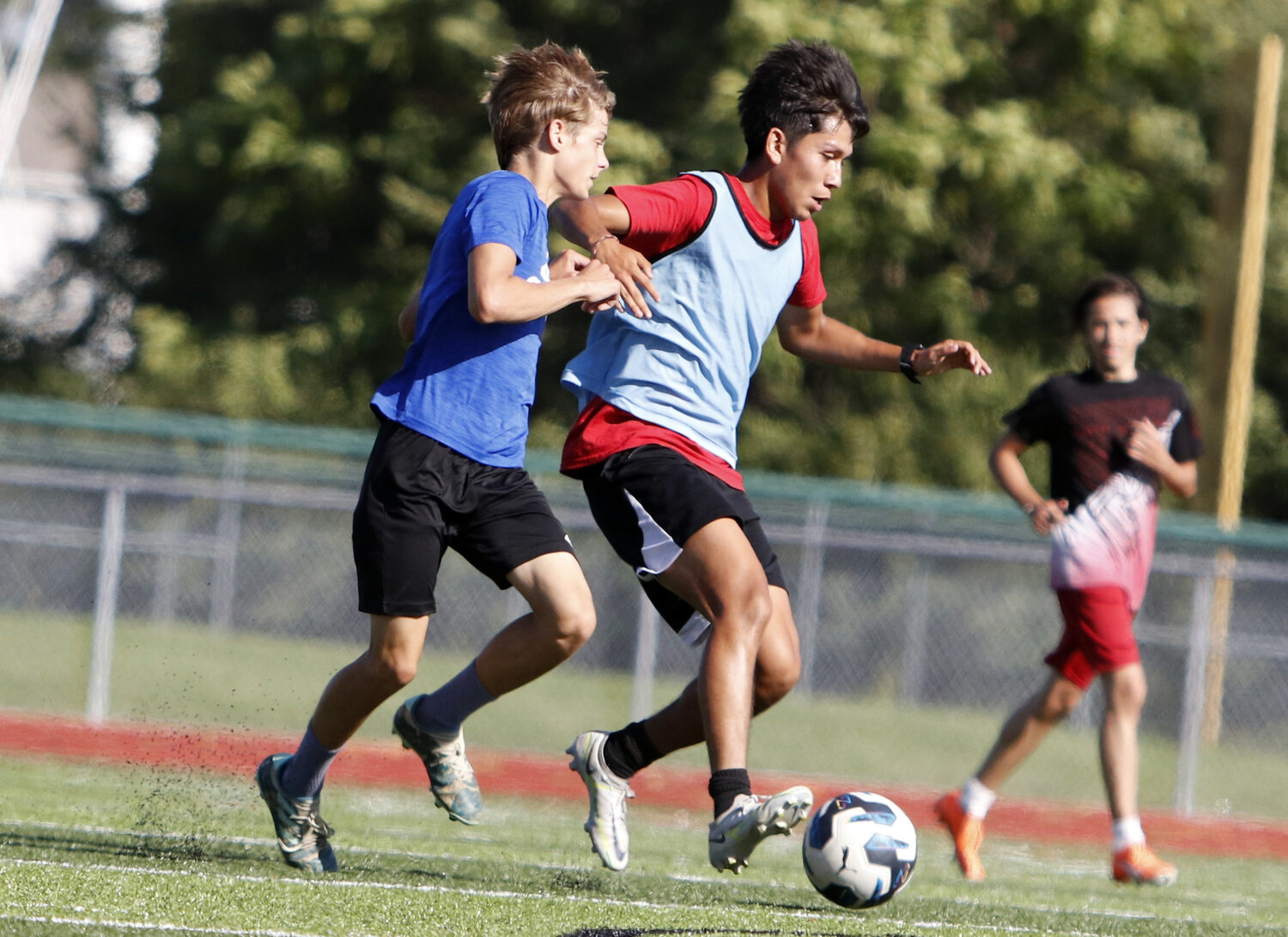 Warrenton senior Bryan Guerrero (right) gains control of the ball during an August practice.