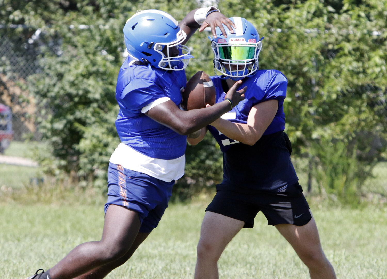 Wright City quarterback Joey Gendron (right) hands the ball off to Carleon Jones during a practice earlier this month.