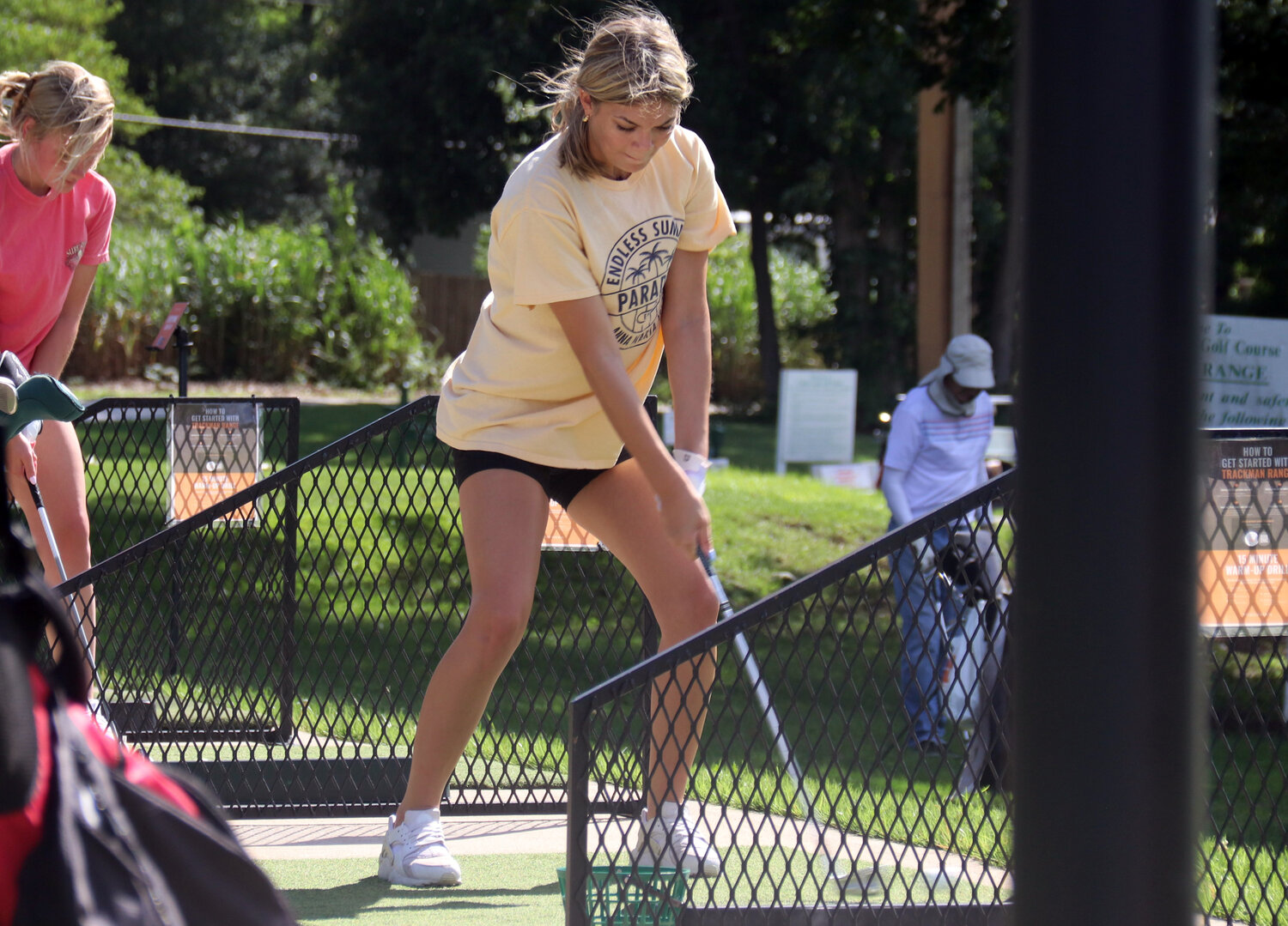 Sierra Foley sets up before swinging her club at the driving range during a practice earlier this month.