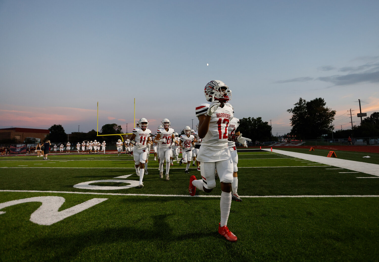 Warrenton's Chance McPike (12) enters the field before a game against Fort Zumwalt South, Friday, Aug. 25, 2023, at Fort Zumwalt South High School in St. Peters, Mo.