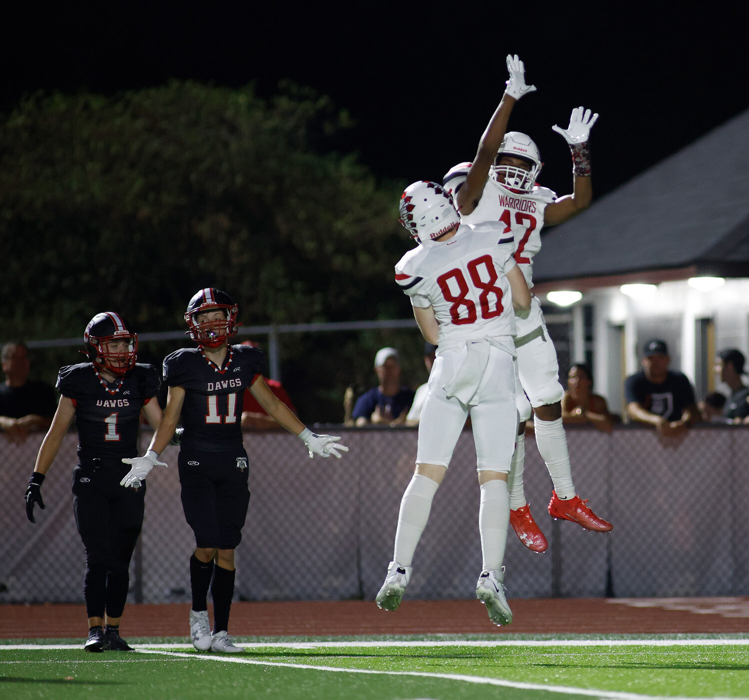 Warrenton's Chance McPike (12) and Evan Schenck (88) celebrate a touchdown, Friday, Aug. 25, 2023, at Fort Zumwalt South High School in St. Peters, Mo.