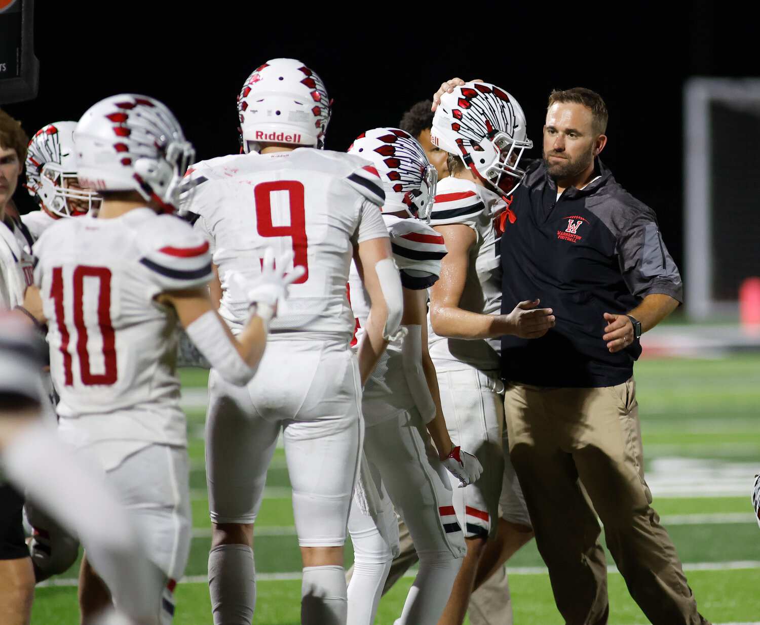 Warrenton head coach Jason Koper celebrates with his team after defeating Fort Zumwalt South, Friday, Aug. 25, 2023, at Fort Zumwalt South High School in St. Peters, Mo.