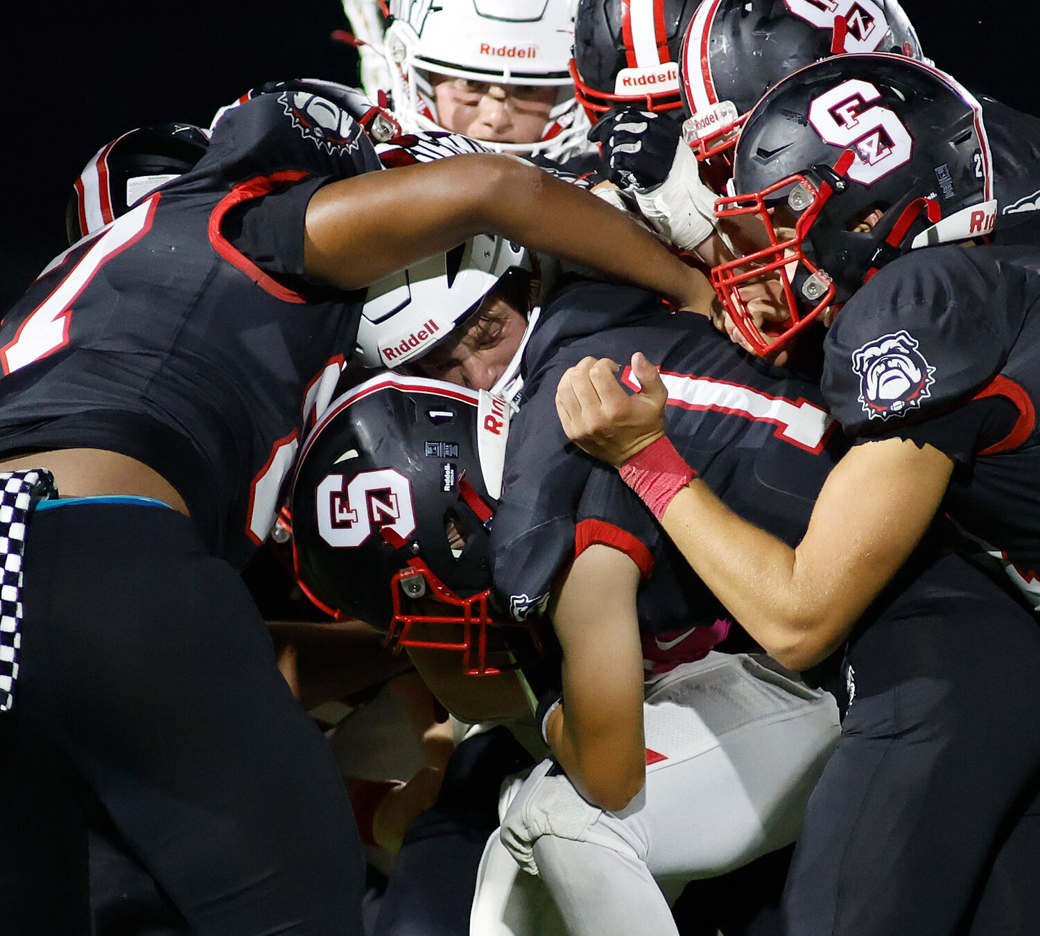 Warrenton's Austin Haas (7) carries the ball and is tackled by a number of Fort Zumwalt South players, Friday, Aug. 25, 2023, at Fort Zumwalt South High School in St. Peters, Mo.