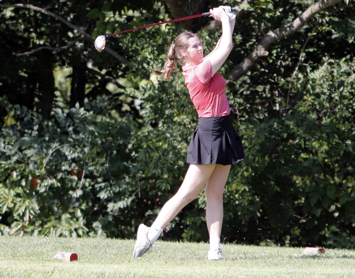 Haley Rausch looks on after hitting a tee shot at the third hole during Monday’s competition at Country Lake Golf Club.