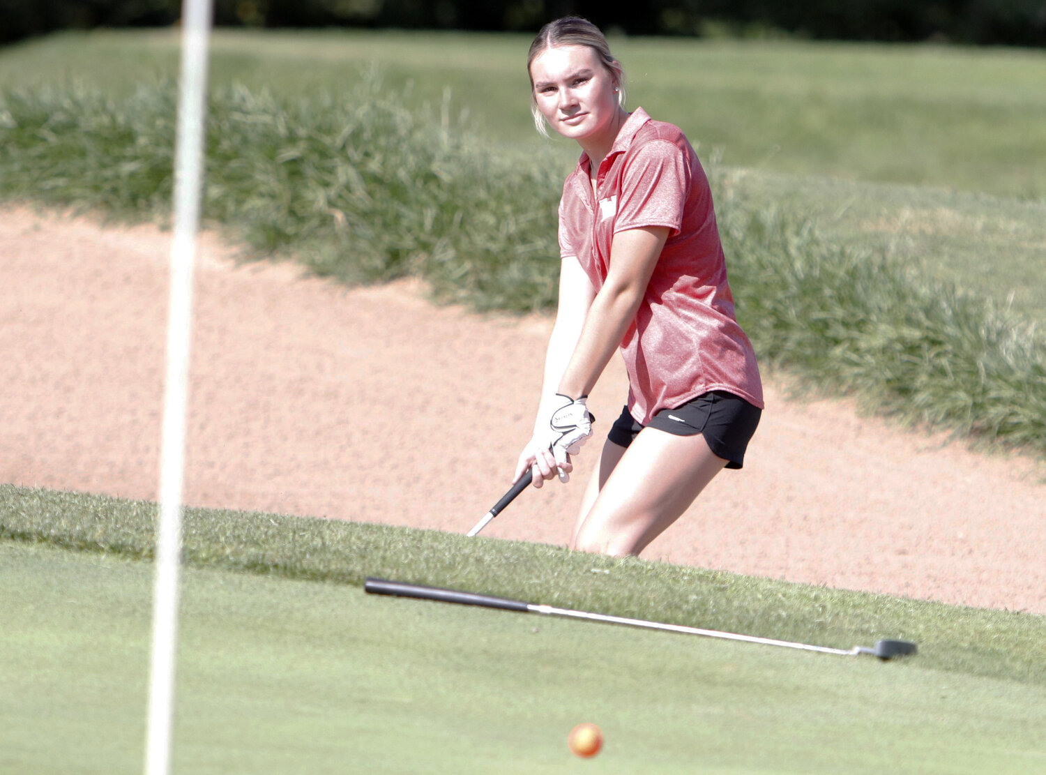 Jenna Marschel looks on after hitting out of the bunker at the first hole at Country Lake Golf Club.