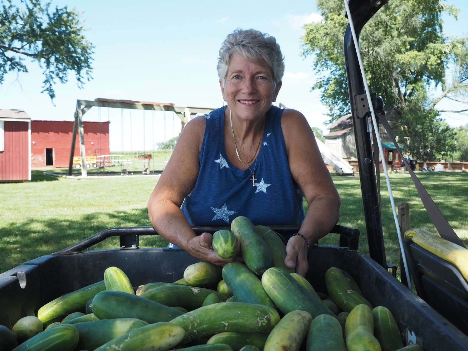 4-H Hall of Fame inductee Ardell Mikus poses with some of her homegrown cucumbers.