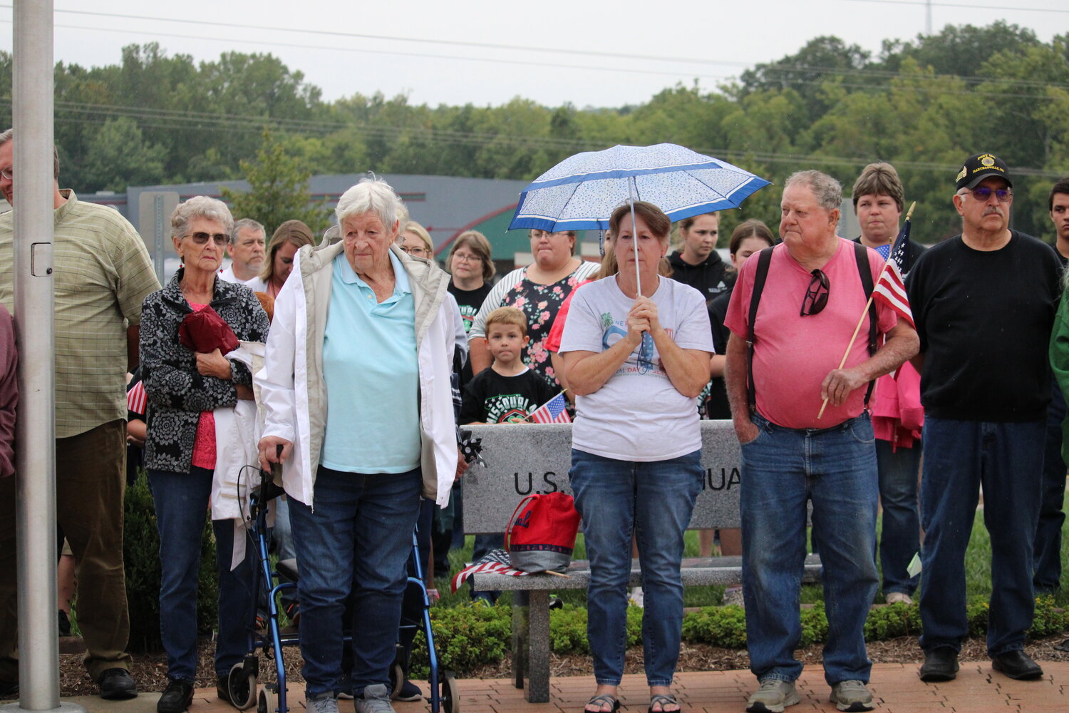 Members of the crowd stand during the Sept. 11 ceremony.