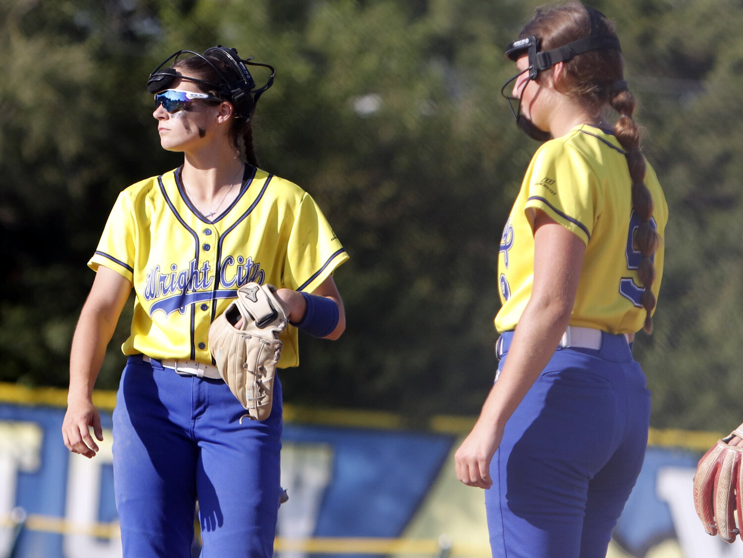 Lydia Clubb (left) and Lillian Brown look on during a mound visit.