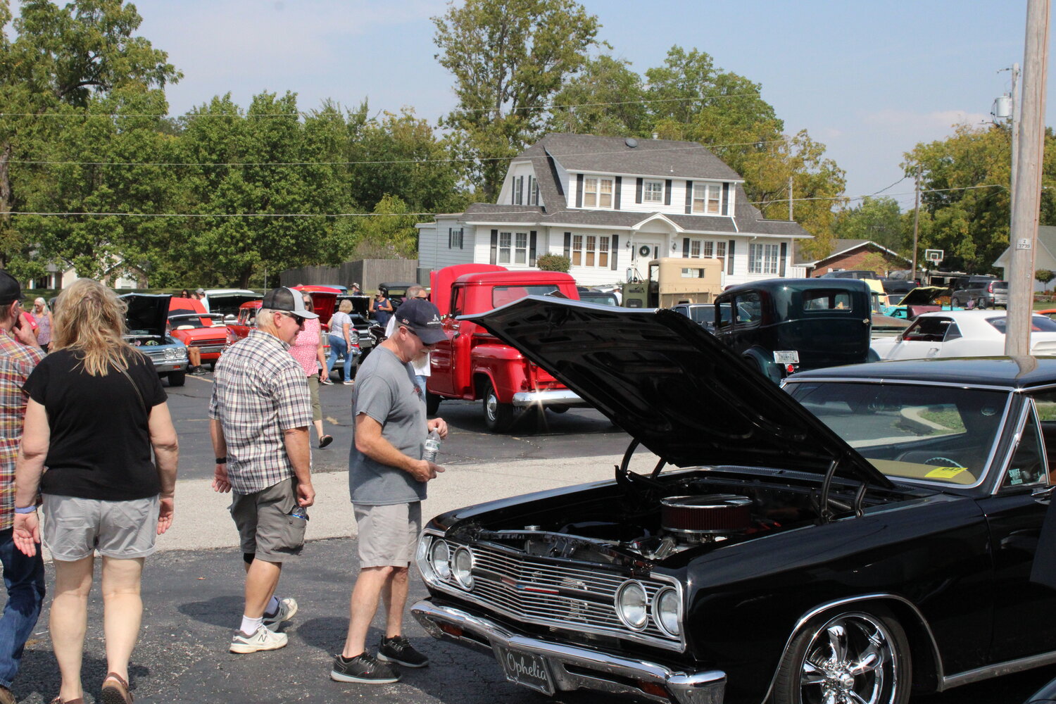 A man checks out one of the many cars on display at the car show.