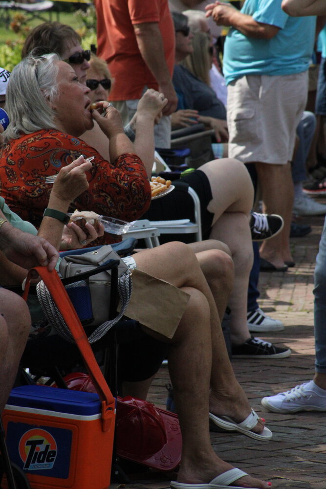 A woman enjoys her funnel cake during the Fall Festival.