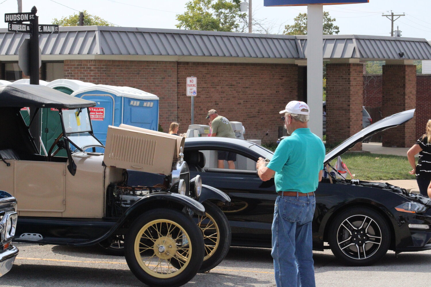 A man checks out one of the cars at the car show.